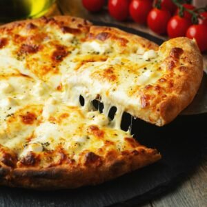 A slice of hot Italian pizza with stretching cheese. Pizza four cheeses with basil.