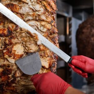 Fried meat on a skewer for cooking of donors or shawarma. Close-up