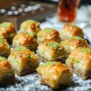 side view traditional turkish baklava with pistachios on a stand